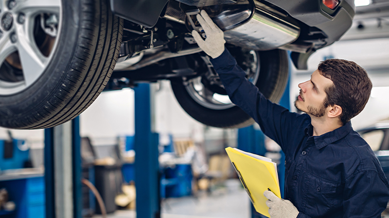 Mechanic inspecting car